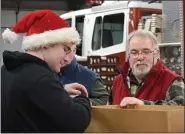  ?? MARIAN DENNIS — MEDIANEWS GROUP ?? Mercury reporter Evan Brandt and son, Dylan, have made a family tradition of showing up every year to help pack boxes of food for area families as part of Operation Holiday.