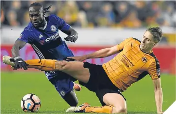  ??  ?? ■Wolves’ Dave Edwards tackles Chelsea’s Moses.