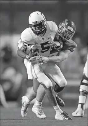  ?? STEVE CONNER/AP PHOTO ?? UConn quarterbac­k David Pindell (5) is wrapped up by Boise State’s Matt Locher during last Saturday’s loss in Boise, Idaho. The senior has been the Huskies’ most productive offensive player, although he was held in check by the Broncos.