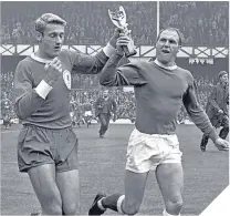  ??  ?? Roger Hunt and fellow-World Cup winner, Everton’s Ray Wilson, parade the Jules Rimet trophy at the 1966 Charity Shield match. sundaypost.com