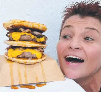  ?? Picture: MIKE BATTERHAM ?? Valerie Teofanov gets the lowdown on the pancake burger.