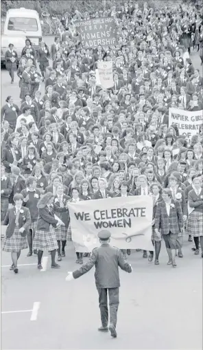  ?? PHOTO / COLLECTION OF HAWKE’S BAY MUSEUMS TRUST GIFTED BY DAILY TELEGRAPH, 56423 ?? Napier traffic controller Brian Wilkins is confronted with a phalanx of 700 students from Hawke’s Bay girls’ schools marching to celebrate women’s suffrage in 1993 — and, hey Brian, again there’s no stopping them.