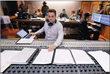  ?? MARK HUMPHREY/AP PHOTO ?? Nick Spezia works in the control room during the recording of a video game soundtrack in Nashville, Tenn.