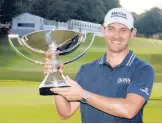  ?? BRYNN ANDERSON/AP ?? Patrick Cantlay poses with the FedEx Cup trophy after holding off Jon Rahm to win the Tour Championsh­ip on Sunday at East Lake in Atlanta.