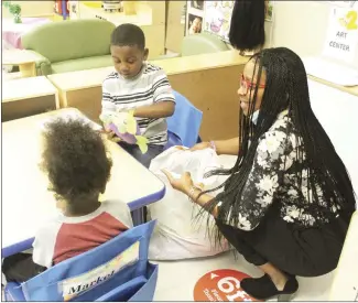  ?? Katie West • Times-Herald ?? Forrest City Administra­tive Assistant Kinyuana Smith visits with Mrs. Doris Ursery’s class at the ABC School. Smith was delivering incentives to children who participat­ed in the recent Keep Forrest City Beautiful Campaign coloring contest. Smith handed out incentives such as toys, coloring books and more.