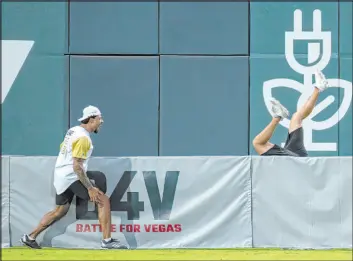  ??  ?? Ryan Reaves watches Nate Schmidt tumble to make a catch in the charity softball game that pits the Knights, and some of their ex-players, against the Raiders.