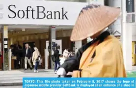  ??  ?? TOKYO: This file photo taken on February 8, 2017 shows the logo of Japanese mobile provider SoftBank is displayed at an entrance of a shop in Tokyo’s shopping district Ginza. — AFP