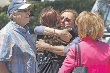  ?? Hayne Palmour IV San Diego Union-Tribune ?? SYNAGOGUE MEMBERS gather outside Chabad of Poway after Saturday’s attack by a lone gunman.