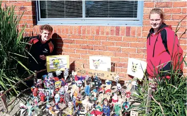  ??  ?? Acting school captain Jack Tobin and school captain Jaime Lilleyman stand next to the Spoonville village created at the Warragul Specialist School last week.