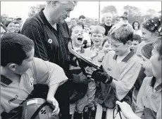  ??  ?? East Cork juvenile GAA Board chairman, Peter Hogan, presents the winning shield to victorious captain Conor Hegarty following St Catherines U11 ground hurling final success over Russell Rovers on a scoreline of 4-1 to 1-0, back in October, 2002. Peter also refereed