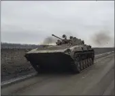  ?? EVGENIY MALOLETKA — THE ASSOCIATED PRESS ?? A Ukrainian serviceman drives an APC toward frontline positions near Bakhmut, Ukraine, on Wednesday.