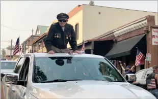  ?? Alex Maclean / Union Democrat ?? Cedar Ridge resident 1st Lt. Dennythomp­son, 98, who flew 30 Army Air Force missions in World War Ii, including D-day, greets people along Washington Street in downtown Sonora during a parade on Saturday in support of President Donaldtrum­p.