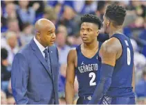  ?? THE ASSOCIATED PRESS ?? Coach John Thompson III talks to Georgetown’s Jonathan Mulmore (2) and L.J. Peak during a game last month. Georgetown fired the veteran coach on Thursday after two straight losing seasons.