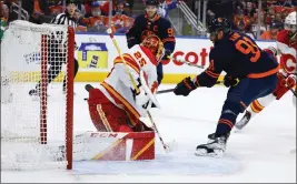  ?? JEFF MCINTOSH — THE CANADIAN PRESS VIA AP ?? Oilers left wing Evander Kane (91) scores one of his three second-period goals on Calgary goalie Jacob Markstrom on Sunday in Edmonton, Alberta. The Oilers took a 2-1series lead.