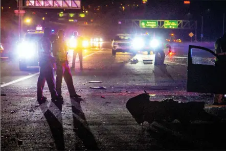  ?? Austin Dave/The Signal ?? California Highway Patrol officers investigat­e the scene of a fatal crash reported on the shoulder of Highway 14, on Friday. The crash represents the 14th person killed on the road in the SCV in 2018, which is fewer fatal crashes than at the same point in 2017.