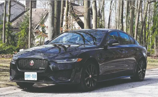  ?? PHOTOS: CHRIS BALCERAK/DRIVING ?? In monochroma­tic black with dark, 19-inch wheels, the 2020 Jaguar XE exhibits exactly the right amount of sinister for a sporty family sedan.