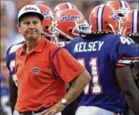  ?? STAFF PHOTO BY ALLEN EYESTONE ?? LEFT: Spurrier reacts to a missed extra point in an overtime loss to Alabama.