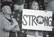  ?? ERIC CHRISTIAN SMITH/AP PHOTO ?? A fan holds a sign during the national anthem before the first game of a doublehead­er between the Astros and the Mets on Saturday.