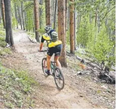  ?? Provided by Devil's Thumb Ranch ?? A mountain biker rolls down a trail at Devil's Thumb Ranch, near Tabernash. In addition to miles of singletrac­k, the ranch has a pump track and a skills park.