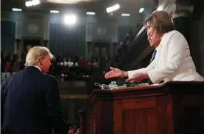 ?? Associated Press ?? ■ President Donald Trump arrives Tuesday evening to deliver his State of the Union address to a joint session of Congress, as Speaker Nancy Pelosi reaches to shake his hand.