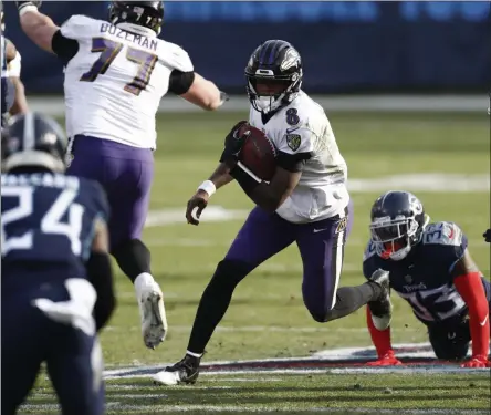  ?? WADE PAYNE - THE ASSOCIATED PRESS ?? Baltimore Ravens quarterbac­k Lamar Jackson ( 8) scrambles against the Tennessee Titans in the second half of an NFL wild- card playoff football game Sunday, Jan. 10, 2021, in Nashville, Tenn.