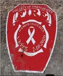  ??  ?? The shields in honor of fallen firefighte­rs Ray Figueroa and Patrick Jones were found — but badly damaged.