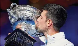  ?? Clive Brunskill/Getty Images ?? Novak Djokovic kisses the Norman Brookes Challenge Cup after winning the men’s singles final at the Australian Open on Sunday in Melbourne, Australia.