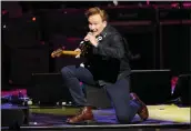  ?? PHOTO BY CHARLES SYKES — INVISION — AP ?? Conan O'Brien performs at the Love Rocks NYC concert benefiting God's Love We Deliver on March 24.