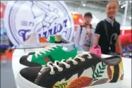  ?? A JING / FOR CHINA DAILY ?? Warrior brand shoes displayed at an industry expo in Beijing.