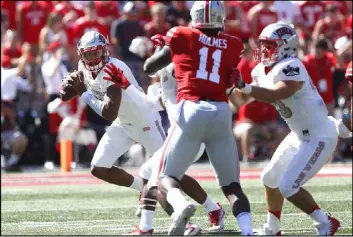  ?? Joe Maiorana USA Today ?? UNLV quarterbac­k Armani Rogers looks for an open receiver as he rolls out during the first quarter of a 54-21 loss to the 10th-ranked Ohio State Buckeyes on Saturday at Ohio Stadium in Columbus, Ohio.