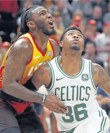  ?? ASSOCIATED PRESS ?? ROUGH STUFF: Marcus Smart battles former teammate Jae Crowder during the Celtics’ loss to the Jazz Friday night.