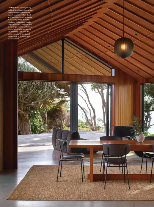  ??  ?? LIVING Metro Series joinery by First Windows & Doors was used throughout the home, powdercoat­ed in Matt Black and with Elemental hardware. In the living zone, picture windows and custom-made raked windows combine with bi-parting over-the-wall sliding doors (which also appear in the kitchen). Tom says the joinery is so well-insulated he was able to do away with curtains here.