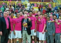  ?? DENNIS KRUMANOCKE­R - FOR DIGITAL FIRST MEDIA ?? Kutztown University coach Bernie Driscoll, center, is congratula­ted by his team and staff after being presented with a commemorat­ive ball recognizin­g his 300th victory at Kutztown last week.