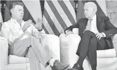  ??  ?? Santos (left) talks with US Vice-President Joe Biden during a meeting at the Casa de Huespedes Ilustres in Cartagena, Colombia. Biden begins a two-day visit to Colombia where he will attend the US-Colombia Business Advisory Council Meeting opening...