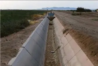  ?? Darryl Webb / Associated Press ?? Climate change, drought and high demand are taking a toll on Arizona farmers. This dry irrigation canal runs through land farmed by Tempe Farming Co. in Casa Grande, Ariz.