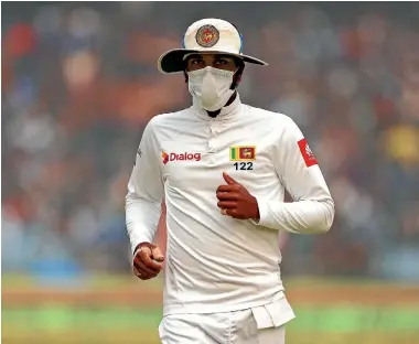  ?? AP ?? Sri Lanka captain Dinesh Chandimal fields wearing an anti-pollution mask during a test match in New Delhi late last year.