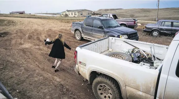  ?? PHOTOS: JABIN BOTSFORD/ THE WASHINGTON POST ?? Moriah Engdahl heads to her sister’s truck for the trip into town to speak against giving teachers in her Wyoming high school guns.