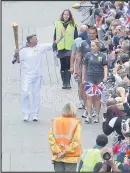  ??  ?? Harry Wells carrying the torch down Market Street