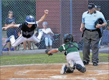  ?? STAN HUDY - SHUDY@DIGITALFIR­STMEDIA.COM ?? North Colonie Bison base runner Nate Maron goes airborne while attempting to avoid the tag by Clifton Park catcherBra­d Curtis in the Cal Ripken 11U Eastern NY State championsh­ip game Monday night.