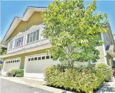  ??  ?? The two-car garage in the home at 24-6110 138th St. in Surrey provides direct access to the open-concept kitchen on the main floor.