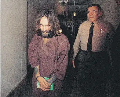  ?? THE ASSOCIATED PRESS FILES ?? In this 1969 file photo, Charles Manson is escorted to court in Los Angeles during an arraignmen­t phase. Manson, cult leader and mastermind behind the 1969 deaths of actress Sharon Tate and several others, died Nov. 19.