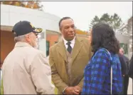  ?? Cassandra Day / Hearst Connecticu­t Media ?? Democratic candidate for Cromwell selectman Myron Johnson greets voters Tuesday morning at Cromwell High School.