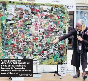  ?? CAMBERLEY WI ?? Craft group leader Josephine Wells points out some of the landmarks featured in Camberley Women’s Institute’s knitted map of the area