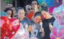  ??  ?? Nicole Maldonado, Myriah Flores and her mother, Sharlene Benavidez, cried for their neighbor, 10-year-old Victoria Martens, who was killed the day she was to celebrate her birthday.