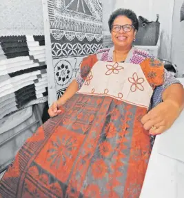  ?? Photo: AZARIA FAREERN. ?? 68-year-old, Maca Likutabua, shows off a dress made by masi which is ready for pickup for a customer from her stall.