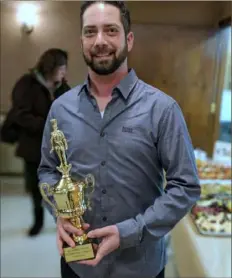  ??  ?? Dave Gagliano displays the trophy to be given to the winner of Mt. Carmel Society’s first Wedding Soup Cook-off.