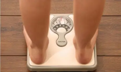  ?? Photograph: Chris Radburn/PA ?? A person weighs themself on some bathroom scales