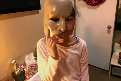  ??  ?? The author’s daughter Nicole, holding the iconic “Phantom” mask.