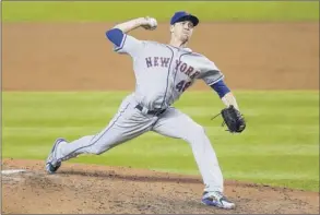  ?? Michael Reaves / Getty Images ?? Jacob degrom of the Mets delivers a pitch against the Marlins on Saturday. He was sharp for five innings before allowing three runs in the sixth inning.