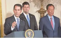  ?? CHRIS KLEPONIS/CNP, TNS ?? Gov. Scott Walker has downplayed the time it will take Wisconsin to recoup the up to $3 billion in incentives from the Foxconn deal. Here, he speaks during the July 26 announceme­nt of the deal, with House Speaker Paul Ryan (R-Wis.) and Foxconn Chairman...